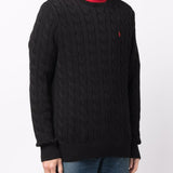 Black sweater worn by a person, showing the sweater's fit