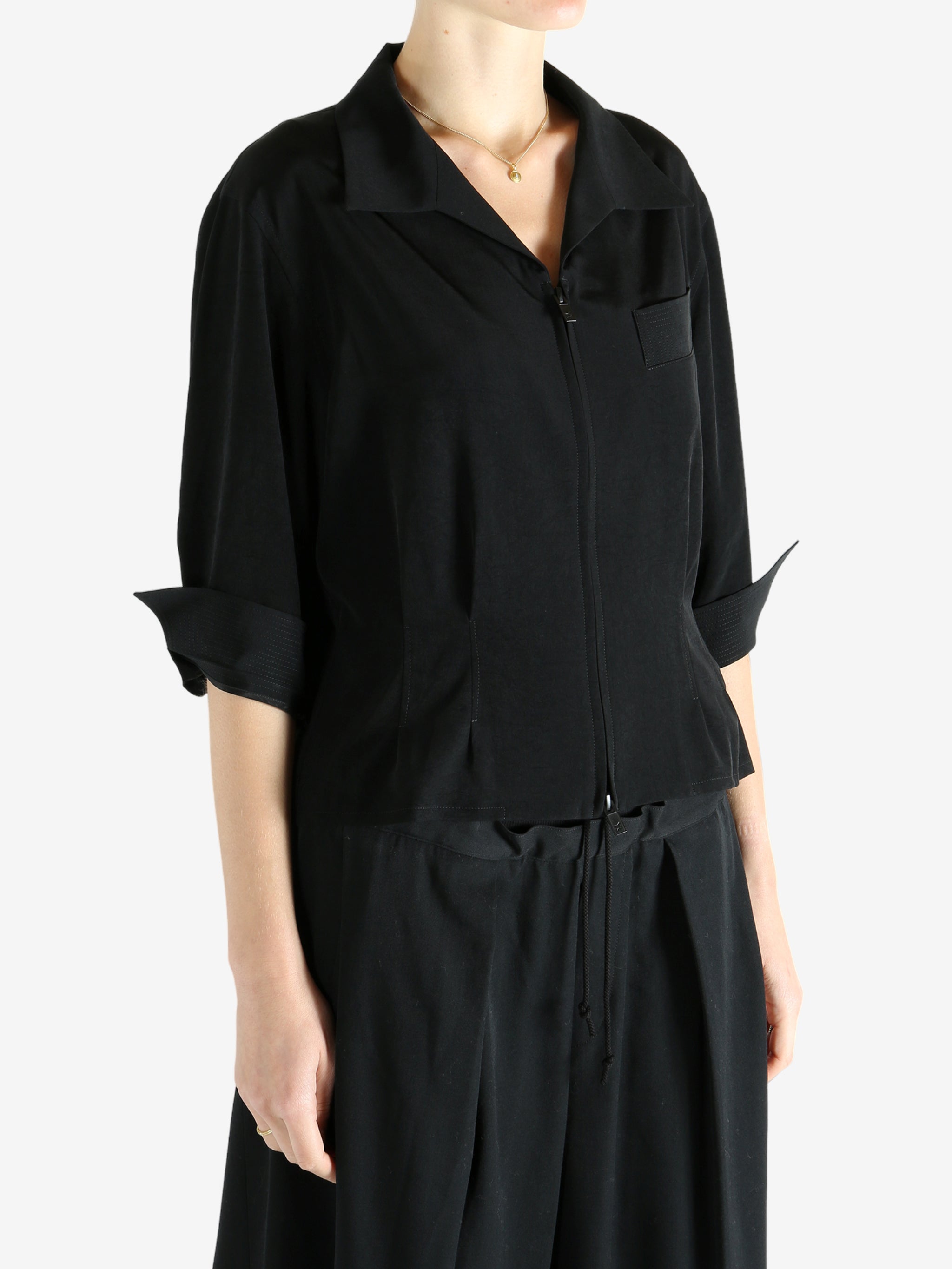 Black shirts worn by a person, showing the shirts fit