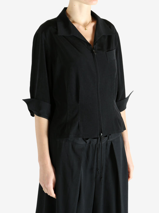 Black shirts worn by a person, showing the shirts fit