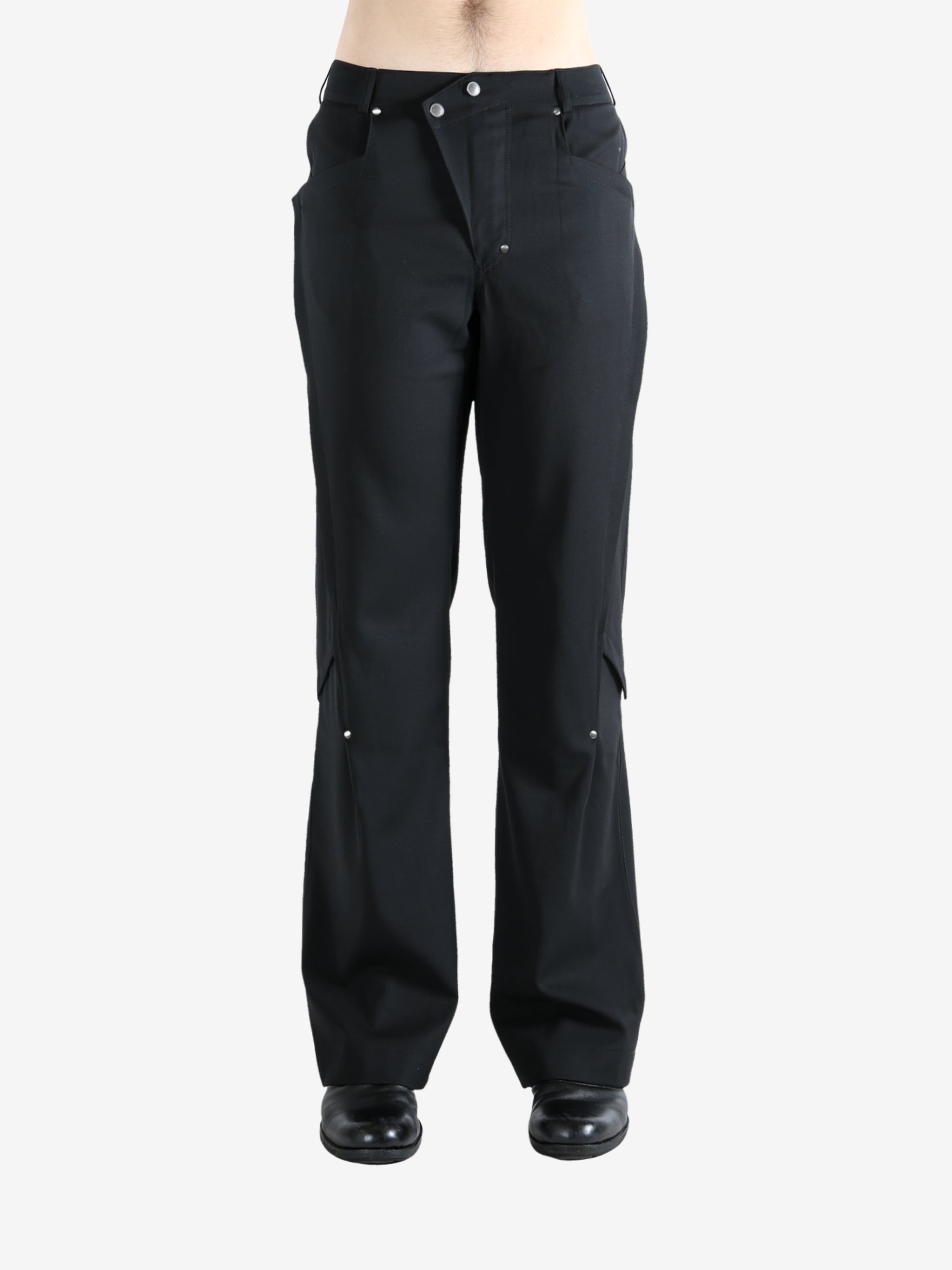 Black pants worn by a person, showing the pants' fit