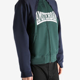 Green sweatshirt worn by a person, showing the sweatshirt's fit
