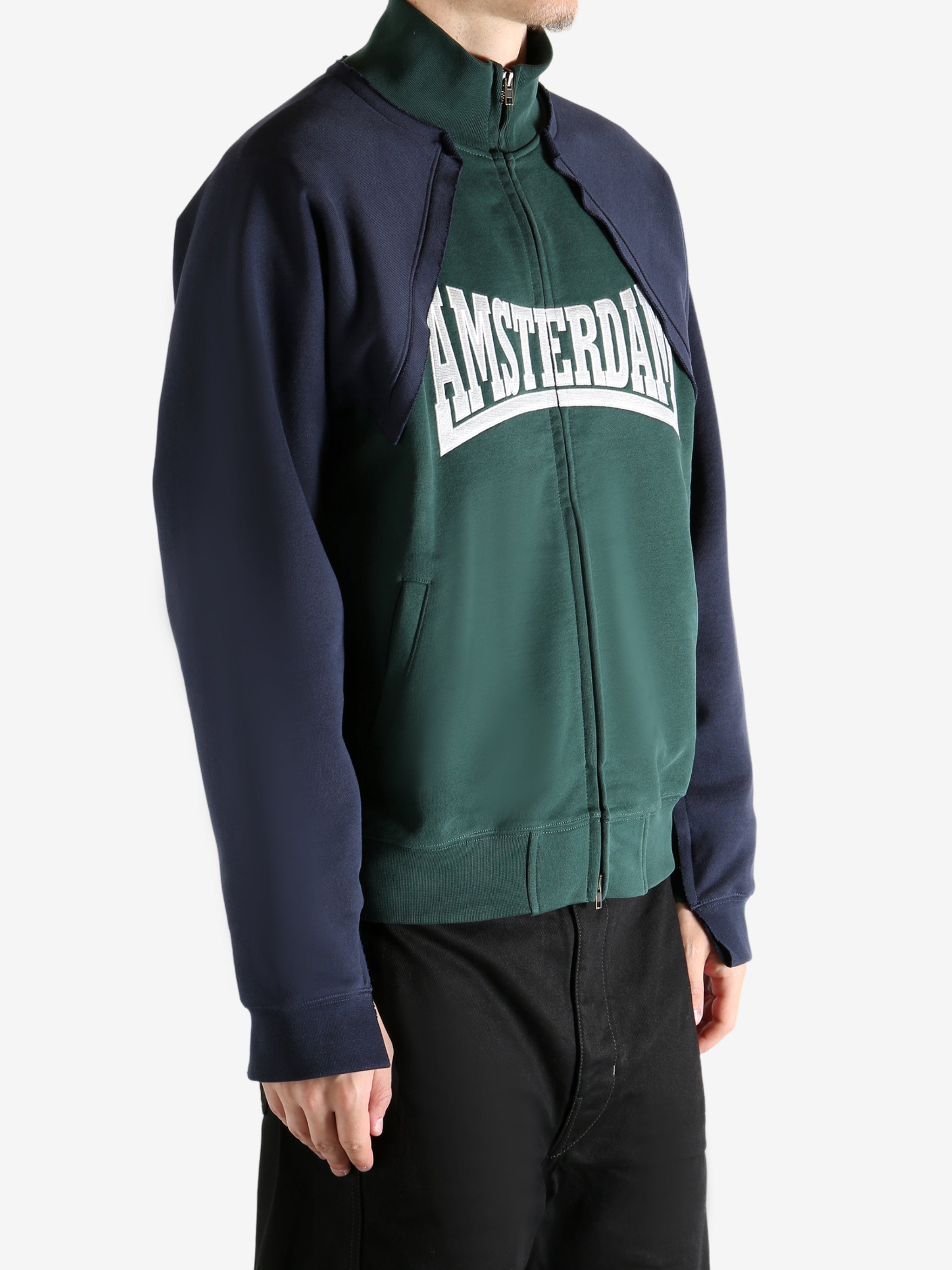 Green sweatshirt worn by a person, showing the sweatshirt's fit