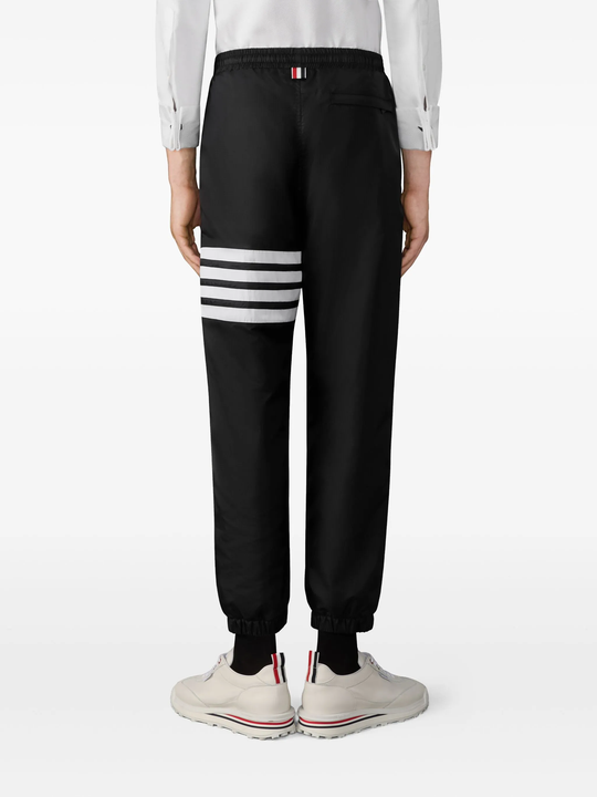 black pants worn by a person, showing the pants fit
