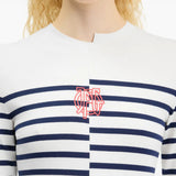 White top worn by a person, showing the top fit