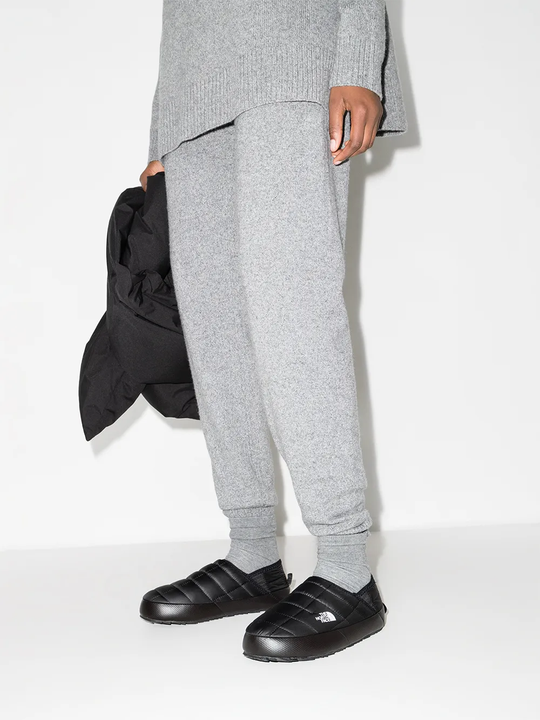 Black shoes worn by a person, showing the shoes fit