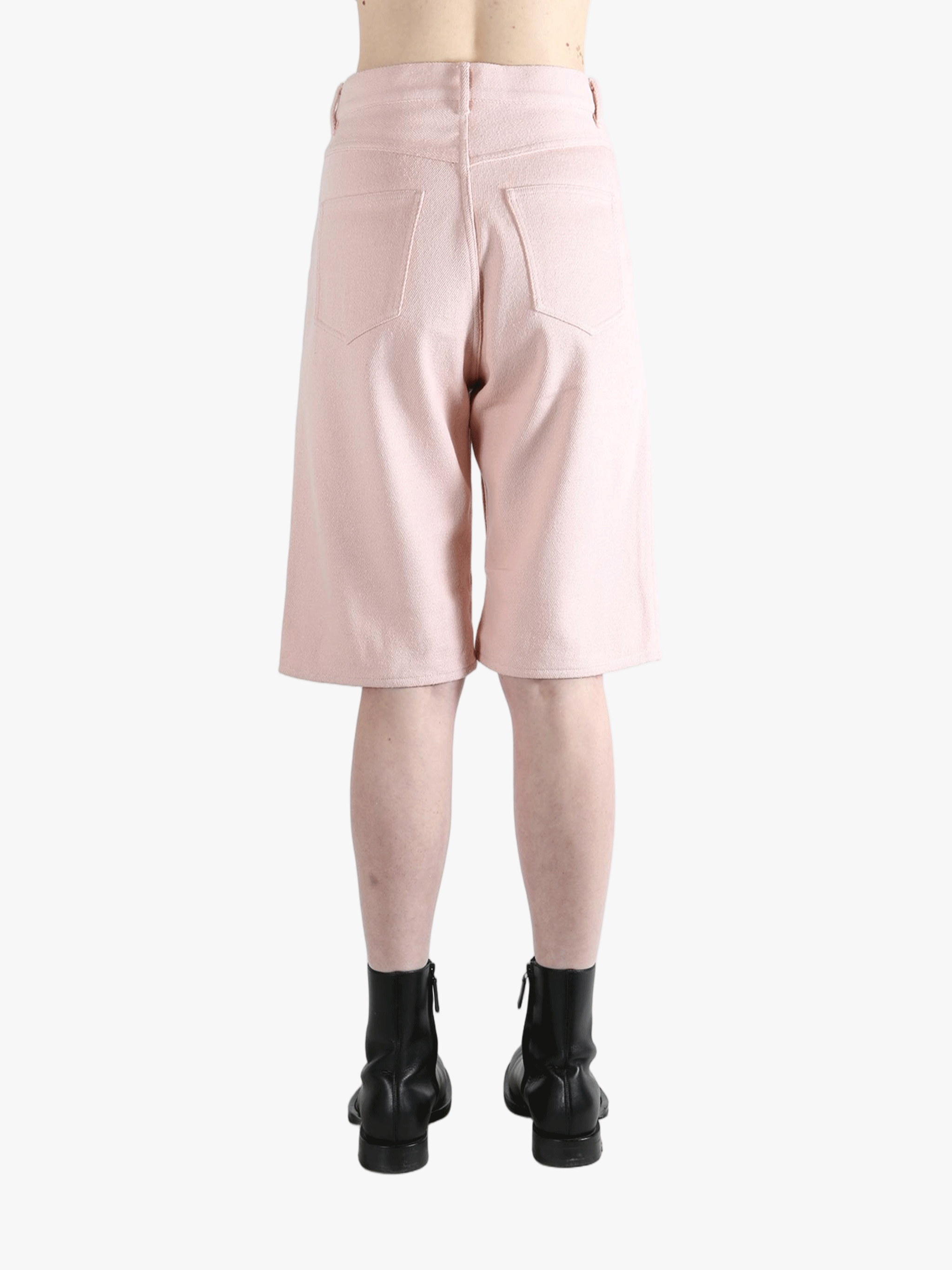 Pink shorts worn by a person, showing the shorts's fit