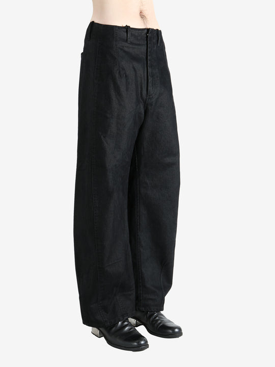 Black pants worn by a person, showing the pants fit