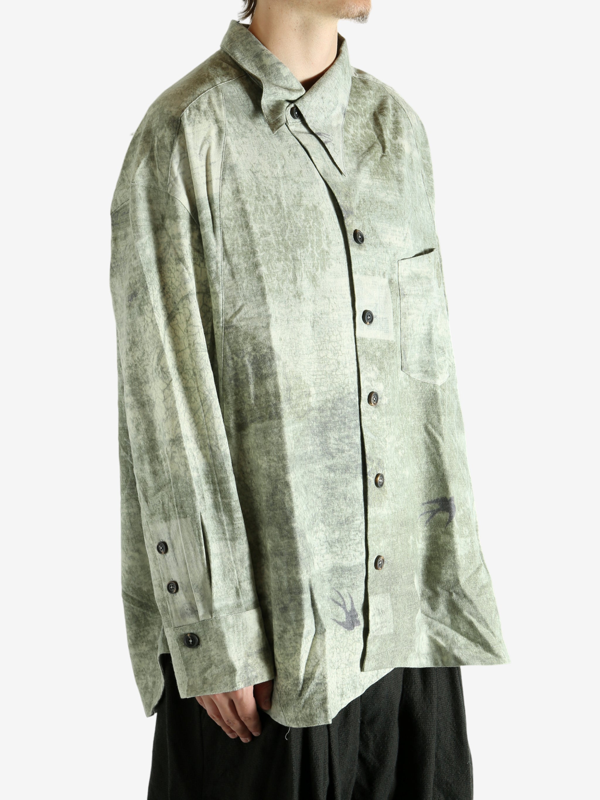 Green shirt worn by a person, showing the shirt's fit