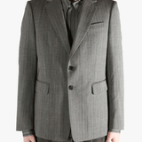 Grey jacket worn by a person, showing the jacket's fit