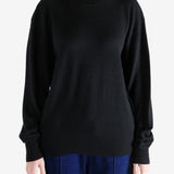 Black knitwear, worn by a person, showing the knitwear's fit