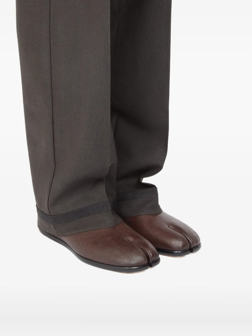 Brown shoes worn by a person, showing the shoes's fit