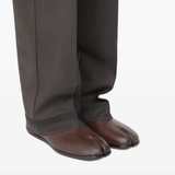 Brown shoes worn by a person, showing the shoes's fit