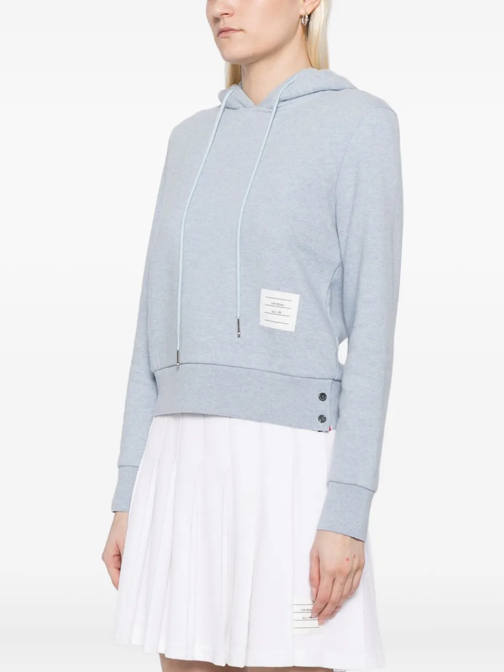 blue hoodie worn by a person, showing the hoodie fit