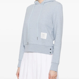 blue hoodie worn by a person, showing the hoodie fit