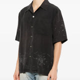 Black shirt worn by a person, showing the shirt fit