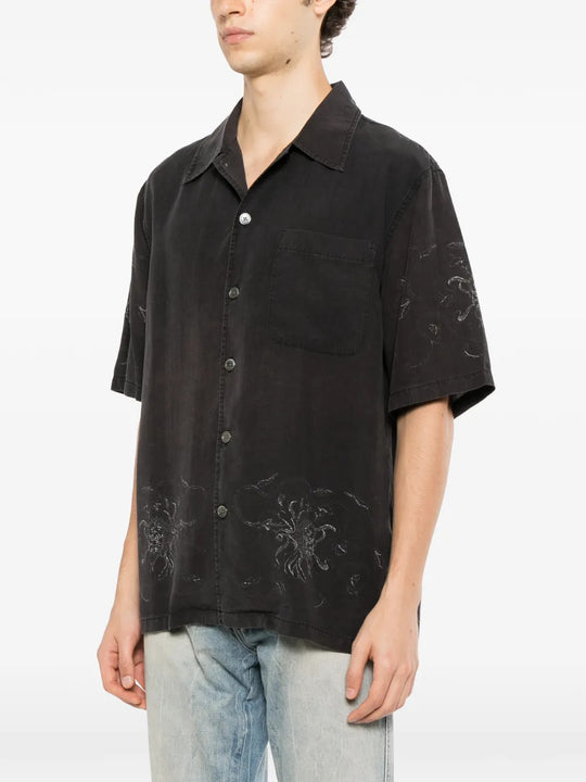 Black shirt worn by a person, showing the shirt fit