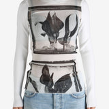 White top worn by a person, showing the top's fit