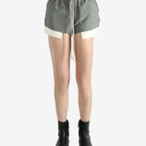 Grey shorts worn by a person, showing the shorts's fit