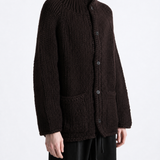 Brown knitwear worn by a person, showing the knitwear fit
