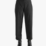 Black pants worn by a person, showing the pants fit