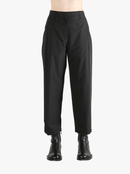 Black pants worn by a person, showing the pants fit