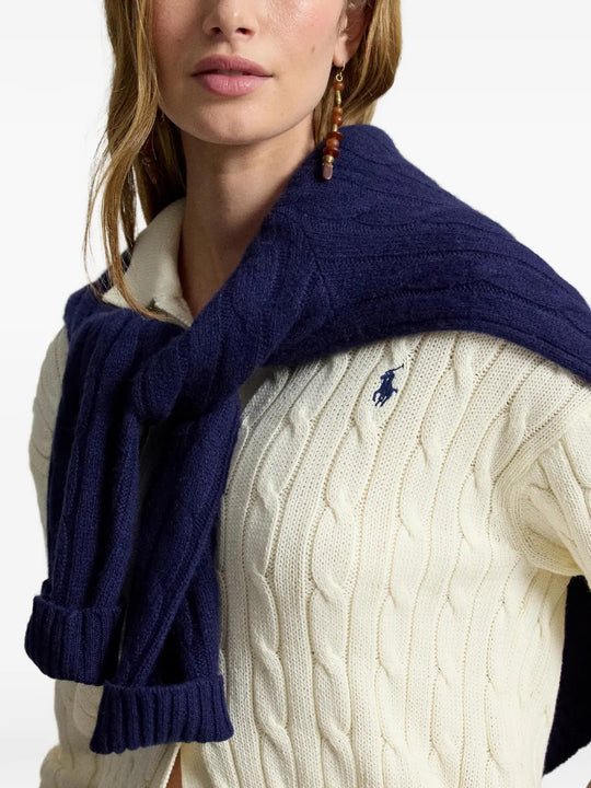 Tan knitwear worn by a person, showing the knitwear fit