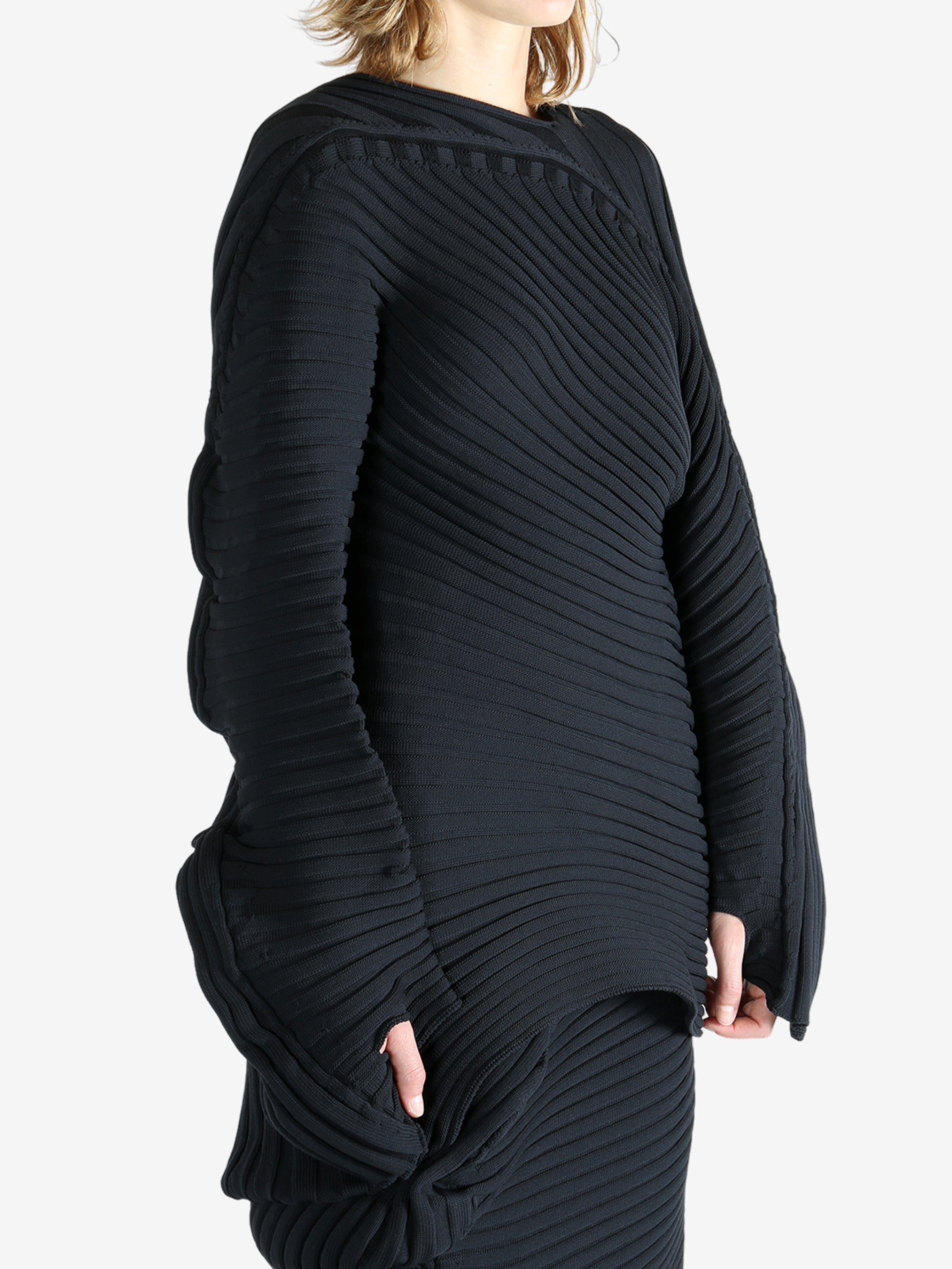 Black top worn by a person, showing the top fit