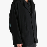 Black jacket worn by a person, showing the  jacket's fit