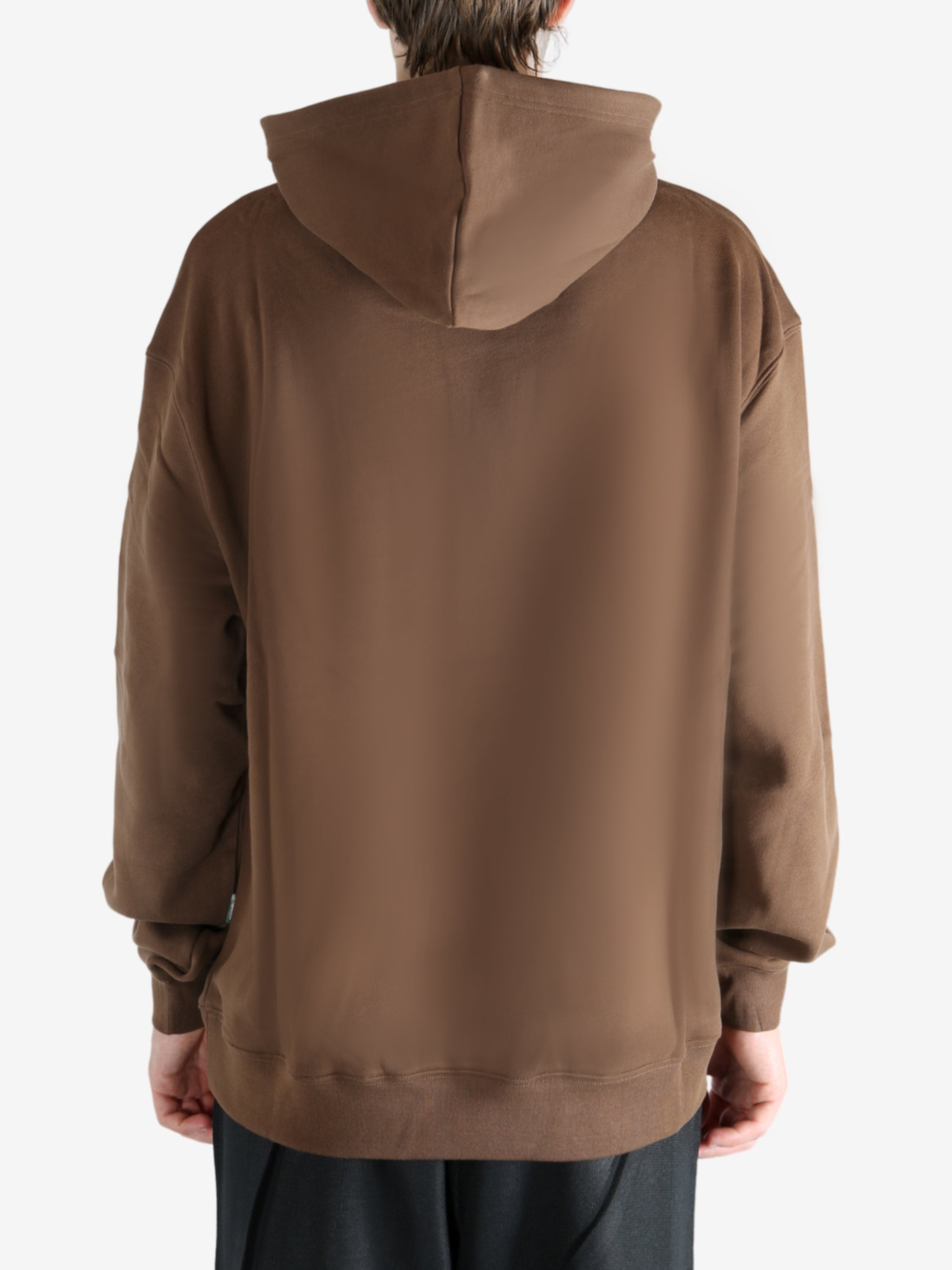 Brown hoodie worn by a person, showing the hoodie's fit