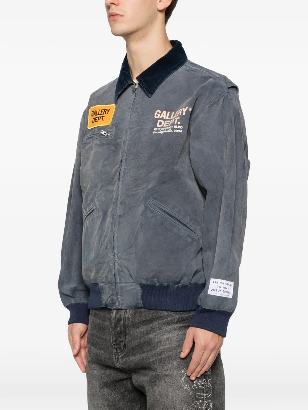 Blue jacket worn by a person, showing the jacket fit