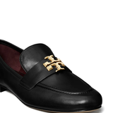 Close up of black loafers-mules, showing texture of the leather fabric