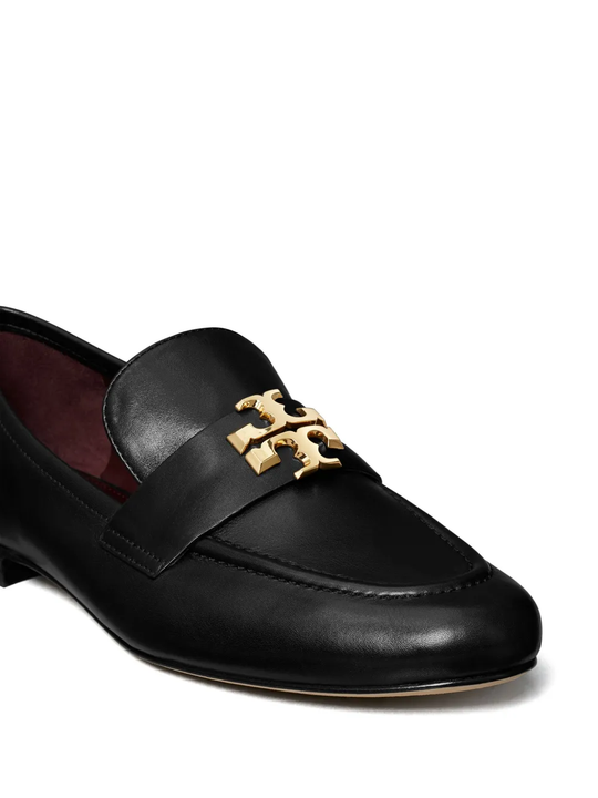 Close up of black loafers-mules, showing texture of the leather fabric