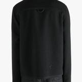 Black jacket worn by a person, showing the jacket's fit