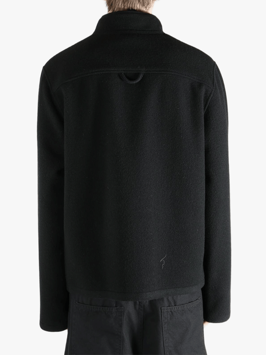 Black jacket worn by a person, showing the jacket's fit