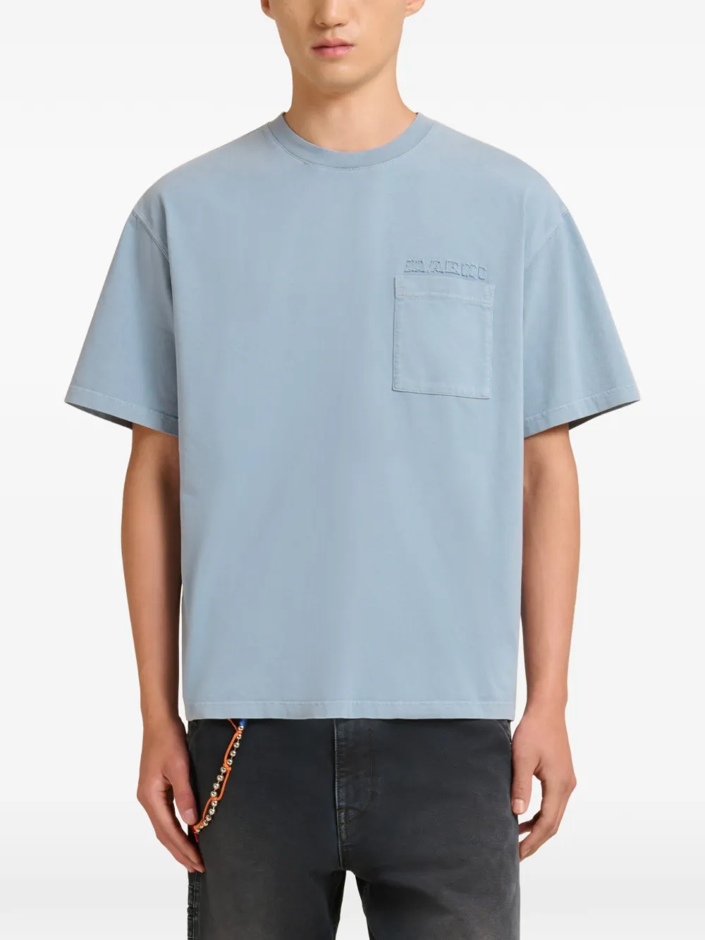 blue t-shirt worn by a person, showing the t-shirt fit