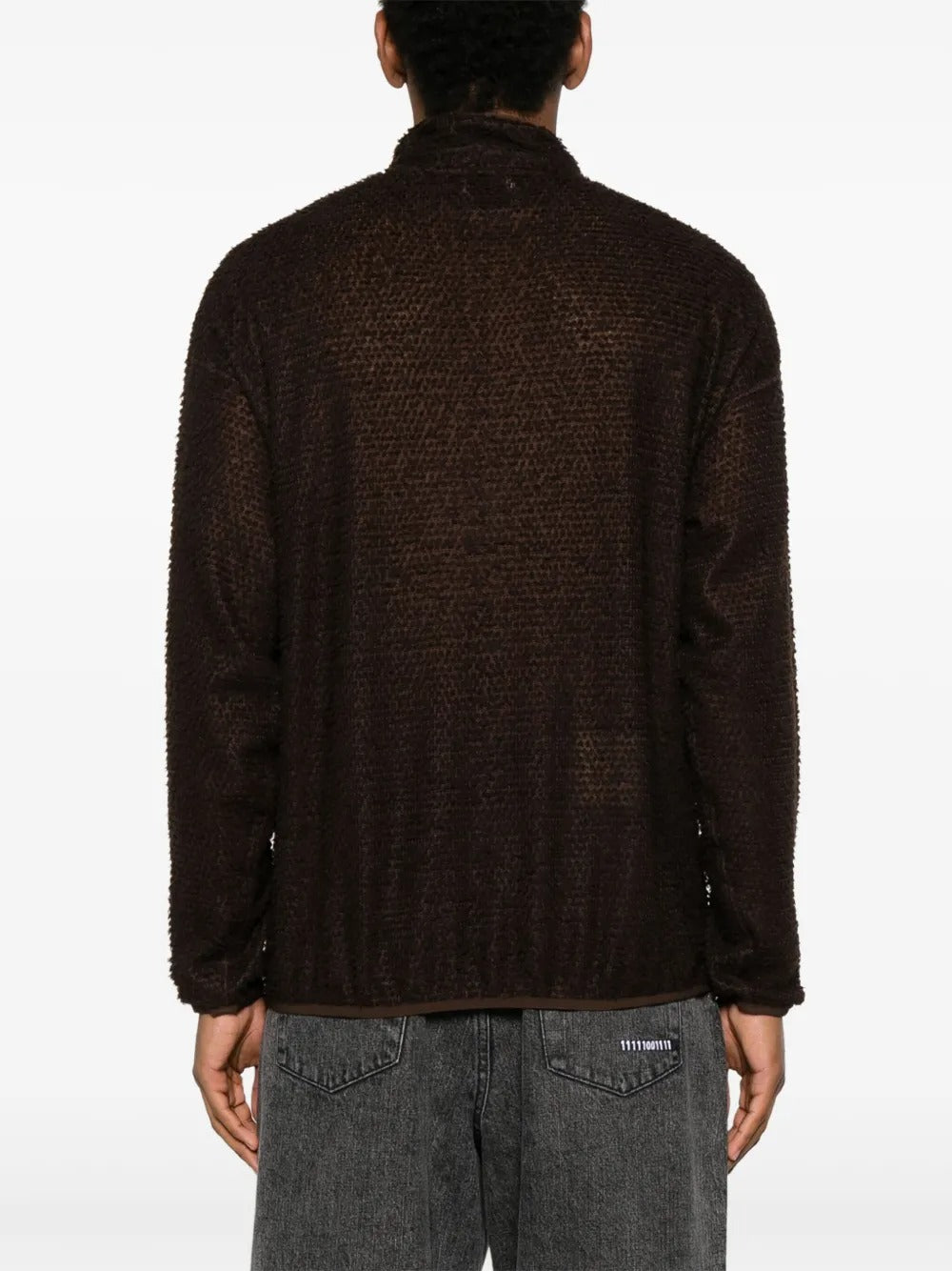 Brown knitwear worn by a person, showing the knitwear's fit