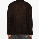 Brown knitwear worn by a person, showing the knitwear's fit