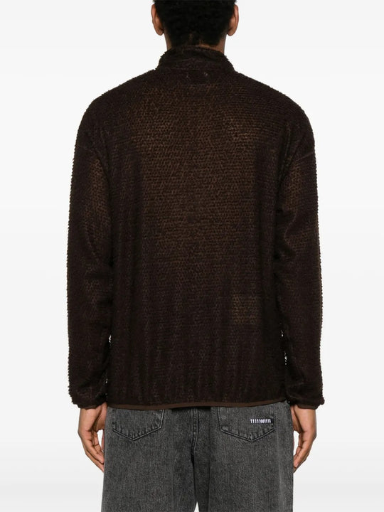 Brown knitwear worn by a person, showing the knitwear's fit