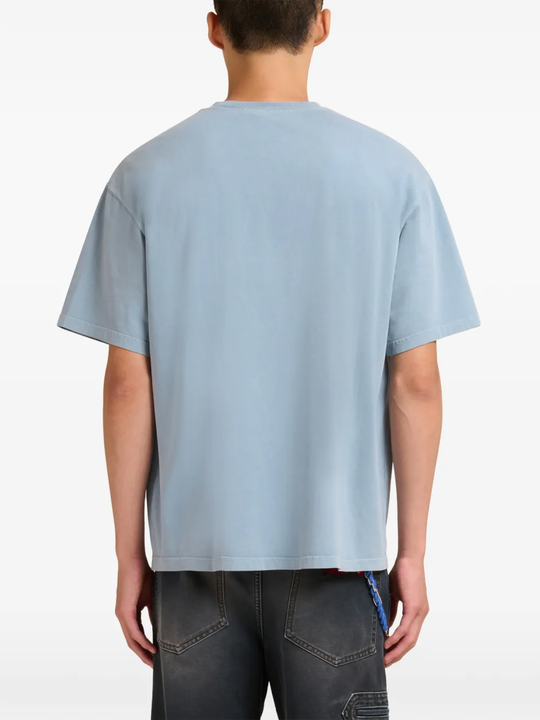 blue t-shirt worn by a person, showing the t-shirt fit