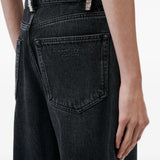 Black jeans worn by a person, showing the jeans fit