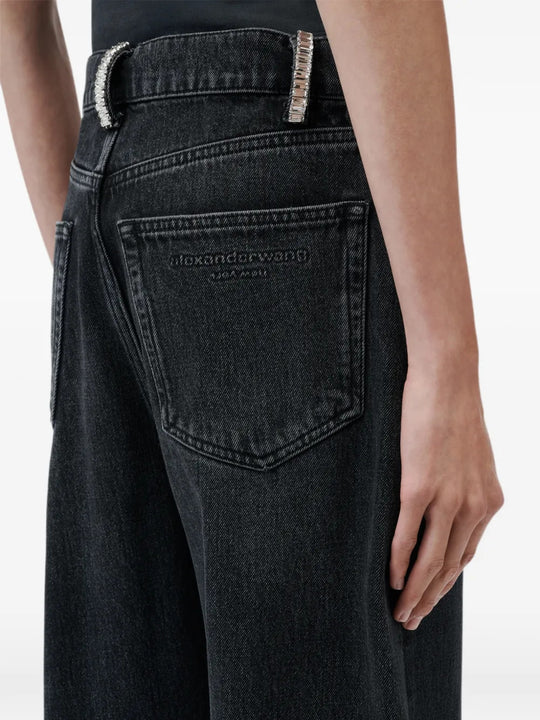Black jeans worn by a person, showing the jeans fit