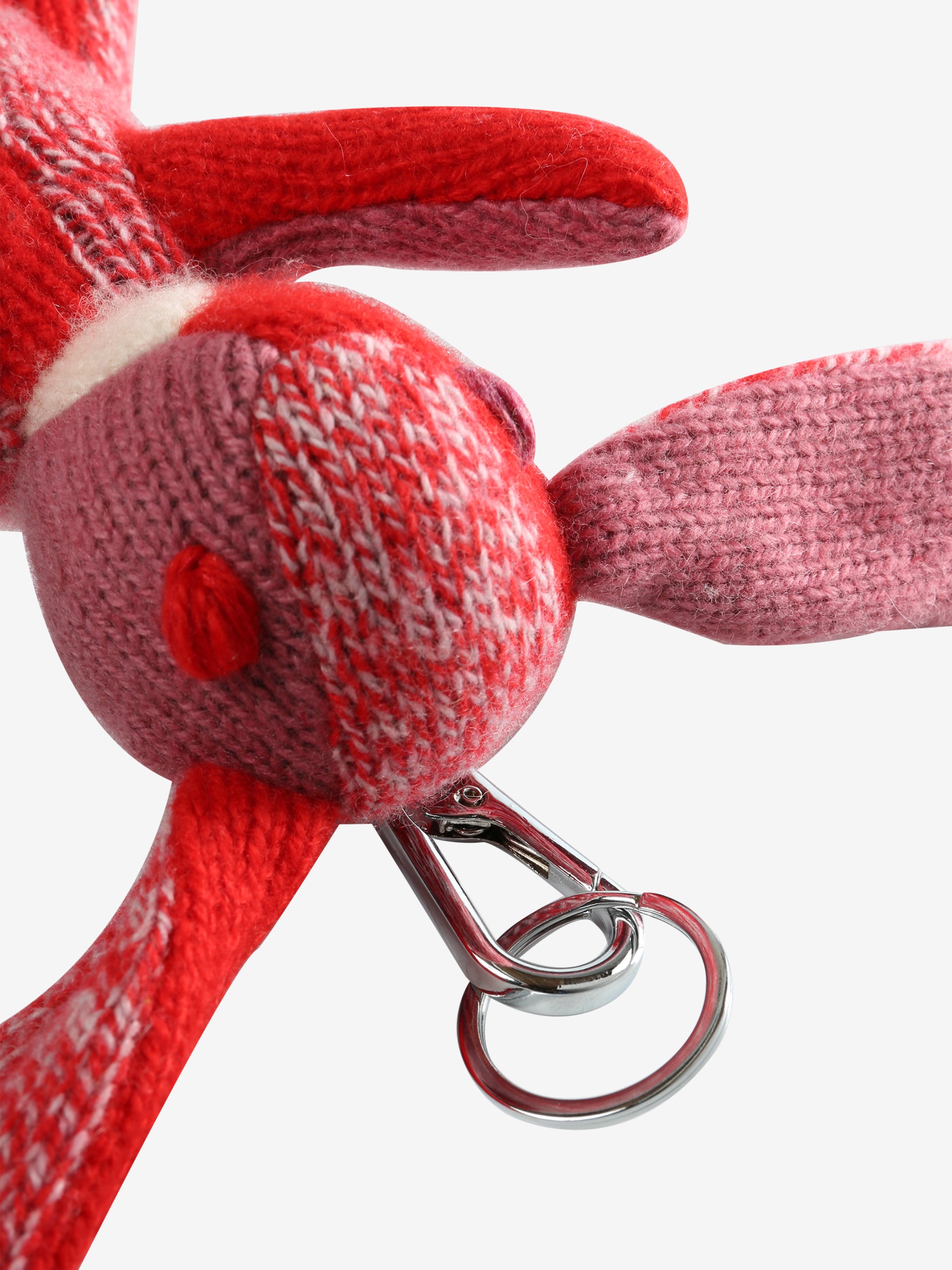 Close up of red keychain, showing texture of the metal clip 