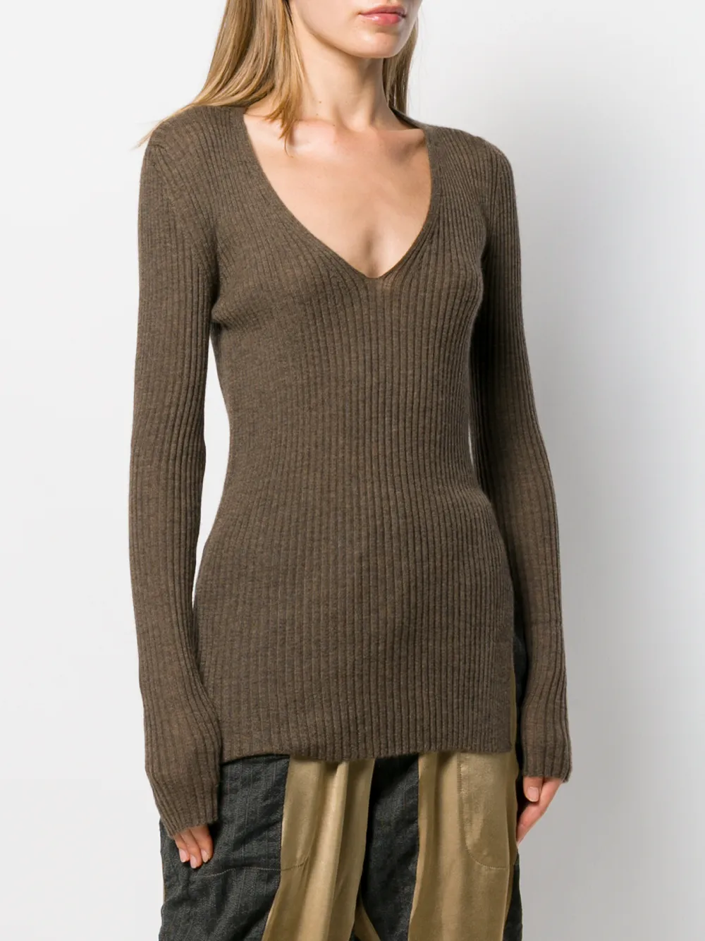 Brown sweater worn by a person, showing the tight fit