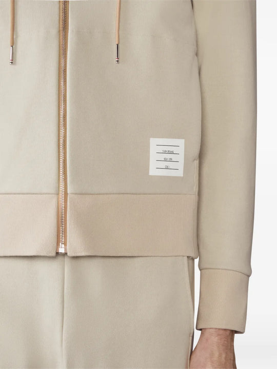 Close up of tan hoodies, showing texture of the cotton fabric