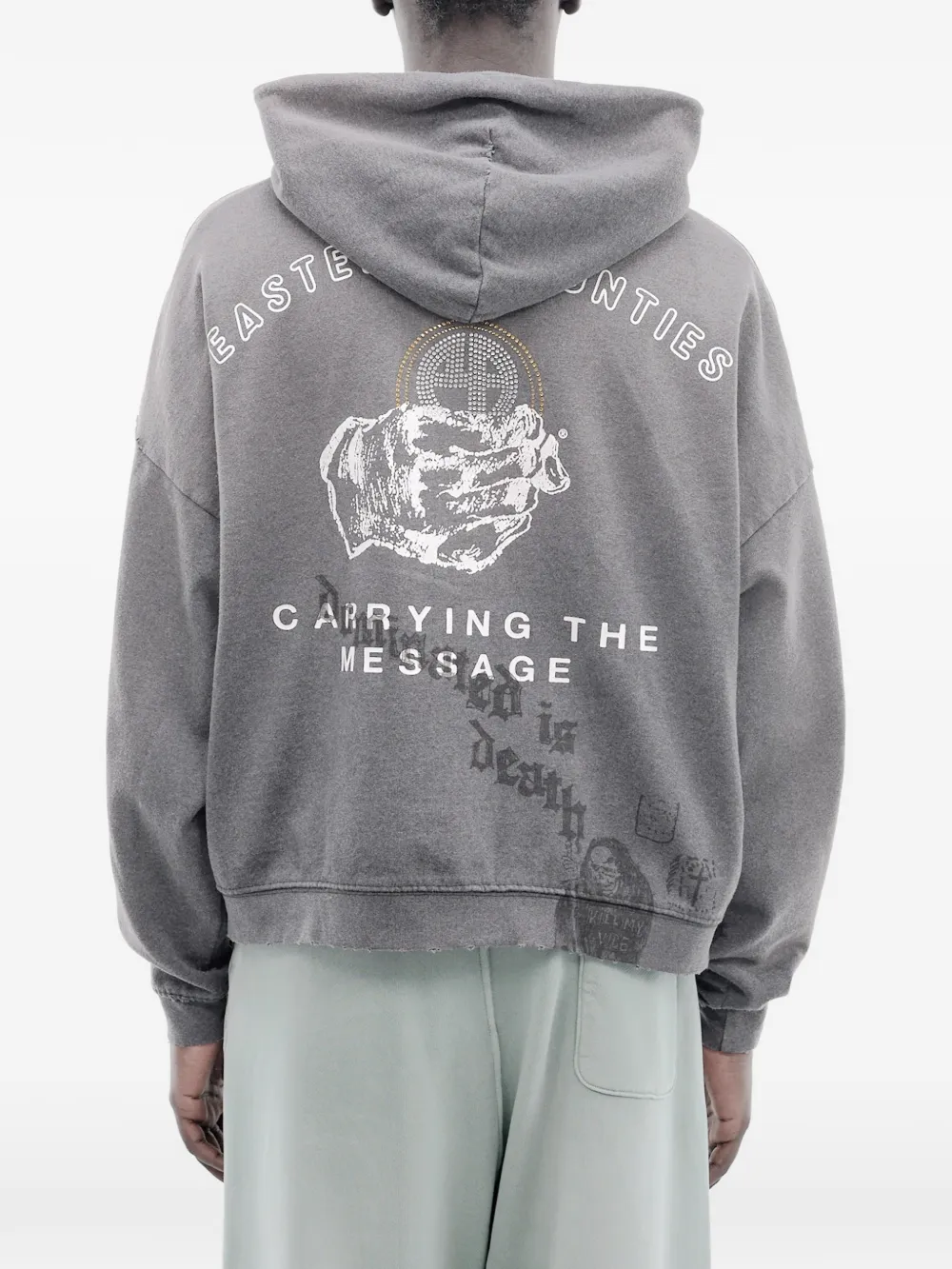 Grey hoodie worn by a person, showing the hoodie's fit