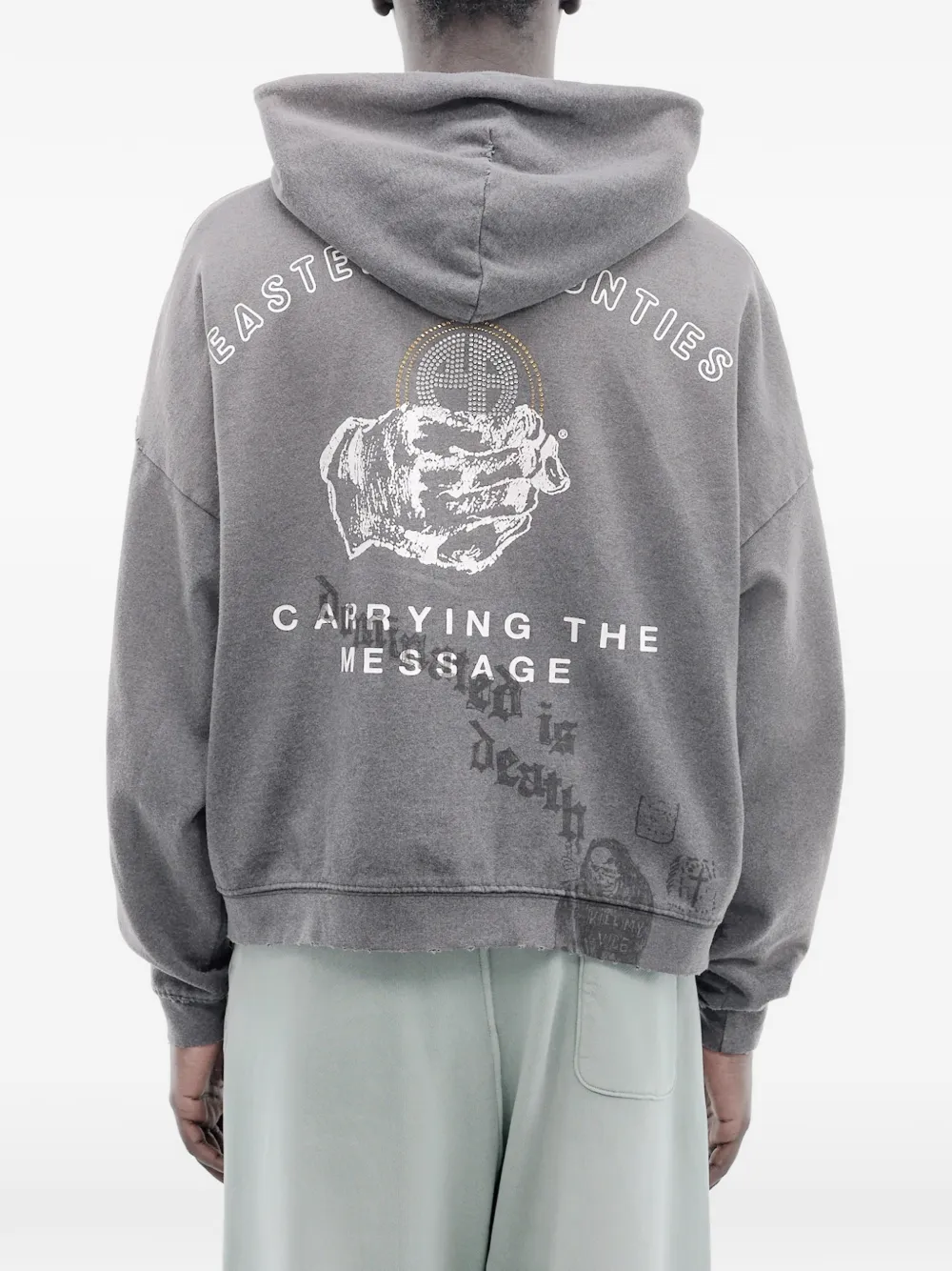 Grey hoodie worn by a person, showing the hoodie's fit