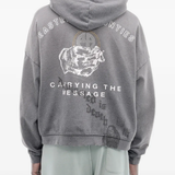 Grey hoodie worn by a person, showing the hoodie's fit