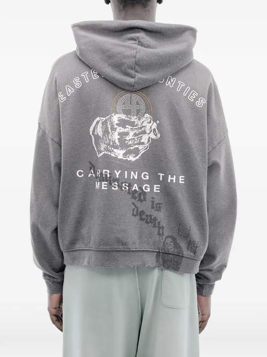 Grey hoodie worn by a person, showing the hoodie's fit