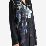 Black shirt worn by a person, showing the shirt's fit