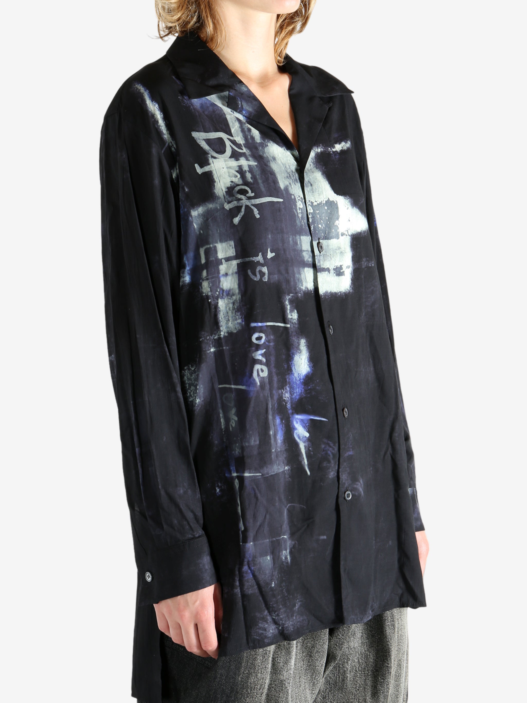 Black shirt worn by a person, showing the shirt's fit